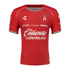 Red Atlas F.C. soccer jersey by Charly featuring white sponsor logos, the club crest, and green and white trim on the collar and sleeve cuffs.
