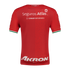 The back of a red Charly soccer jersey with white Seguros Atlas and Akron sponsor logos. The sleeve cuffs feature green, white, and red stripes.