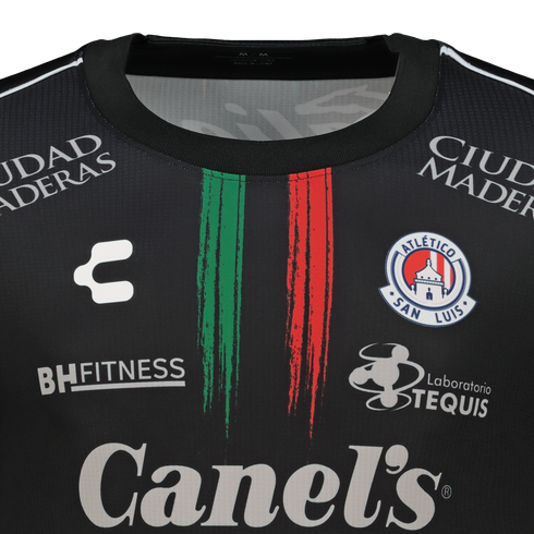 Black Atlético San Luis soccer jersey with central green and red brushstroke stripes, club crest, and various white sponsor logos like Canel's.