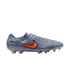 A slate grey Nike Tiempo soccer cleat with an orange and black swoosh and translucent studs, shown in profile against a black background.