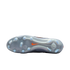 The translucent grey outsole of a Nike soccer cleat with a pattern of studs and an orange swoosh logo, shown against a solid black background.