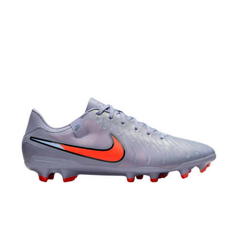 Light purple Nike soccer cleat featuring a large bright orange swoosh and matching red studs against a solid black background.