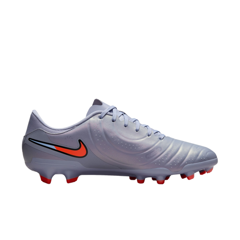 Lavender Nike soccer cleat with a pearlescent finish, featuring an orange swoosh and bright red studs on a black background.