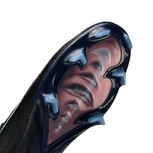 Close-up of a Nike soccer shoe sole with a translucent dark blue plate, light blue studs, and a large pink swoosh visible underneath.