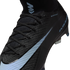 Close-up of a black Nike Mercurial soccer cleat with light blue accents, featuring a textured Gripknit upper, black laces, and an "M" logo on the high-top collar.
