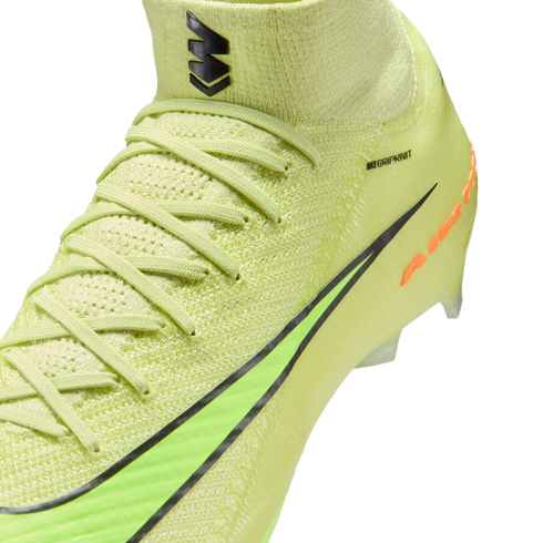 Close-up of a neon yellow Nike soccer cleat with textured Flyknit material, laces, and black accents against a solid black background.
