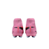 Rear view of a pair of pink Nike Mercurial soccer cleats with black and orange details, set against a black background.