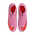 Top-down view of a pair of pink Nike Mercurial soccer cleats with bright orange swooshes on a solid black background.