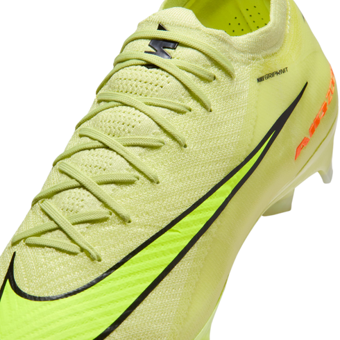 Close-up of a neon yellow Nike Gripknit soccer cleat with a black swoosh and textured upper.