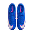 Top-down view of a pair of blue Nike Mercurial soccer cleats with large white and pink swooshes on a black background.