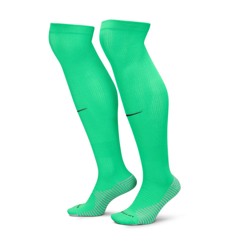 Pair of bright green knee-high athletic socks with black logos on the calves and grey textured heels and toes.