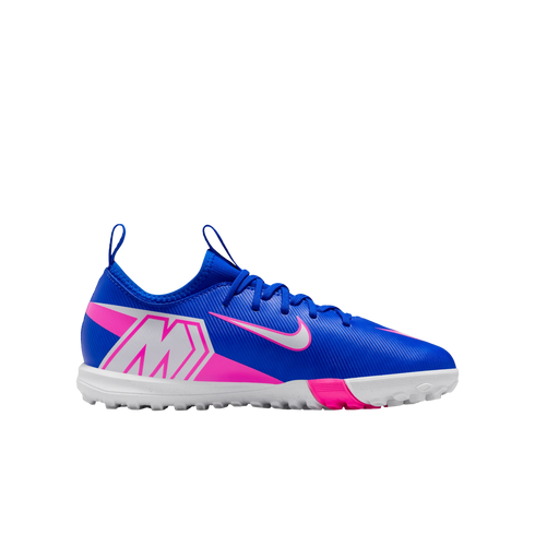 A blue Nike Mercurial turf soccer shoe with white and pink accents, featuring a large "M" logo on the heel, isolated against a black background.