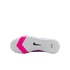 Bottom view of a white Nike shoe with a textured sole, featuring a bright pink chevron band and a black swoosh logo against a black background.