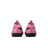 Rear view of two pink Nike Mercurial soccer shoes with black soles and vertical orange branding on the heels against a black background.