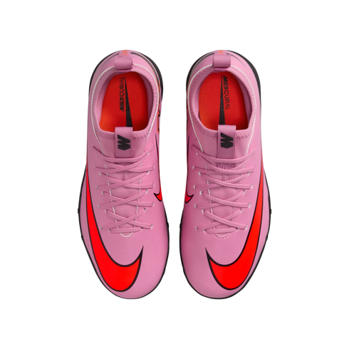 Top-down view of a pair of pink Nike Mercurial soccer cleats with bright orange swooshes on a black background.