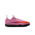 A pink Nike Air Zoom soccer shoe with a vibrant orange swoosh and black sole, shown in profile against a black background.