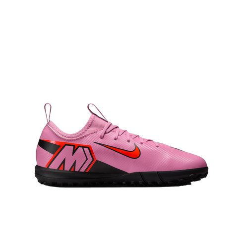 A side-view of a pink Nike Mercurial soccer shoe with a bright red Nike swoosh and a black sole, isolated on a black background.