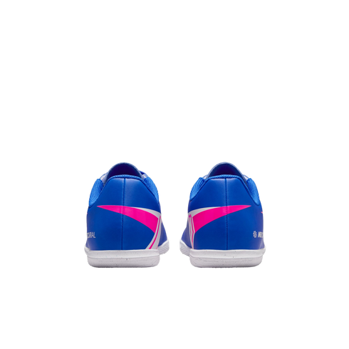 Rear view of blue soccer shoes with bright pink and white accents and white soles on a black background.
