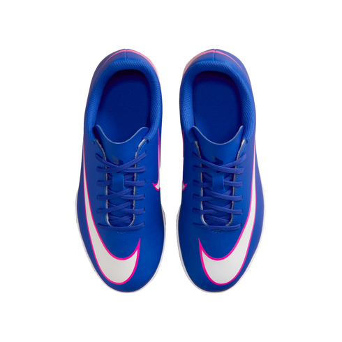 Top-down view of bright blue Nike soccer cleats with white and pink swooshes on a solid black background.