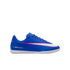 Profile view of a blue Nike Mercurial indoor soccer shoe with a white swoosh outlined in pink and a white sole, set against a solid black background.