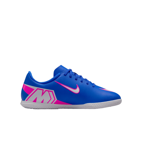 Blue Nike indoor soccer shoe with pink and white accents, featuring a stylized "M" on the heel and a pink swoosh on the side.