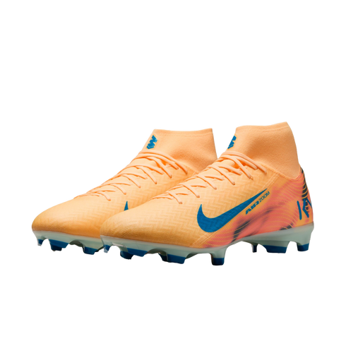 A pair of peach Nike Mercurial soccer cleats with blue accents and high-top collars, set against a solid black background.