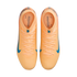 Top-down view of peach Nike Kylian Mbappé soccer cleats with blue accents on a black background.
