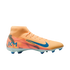 Profile view of a peach and orange Nike soccer cleat with blue accents, featuring a high-top sock collar and a KM logo on the heel.
