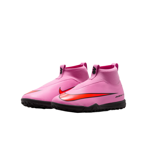 A pair of pink laceless Nike Air Zoom soccer shoes with a red swoosh and black turf soles, set against a black background.