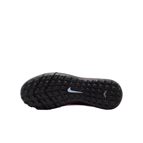 The black rubber outsole of a Nike turf shoe with a white swoosh logo and rectangular traction studs, shown against a black background.