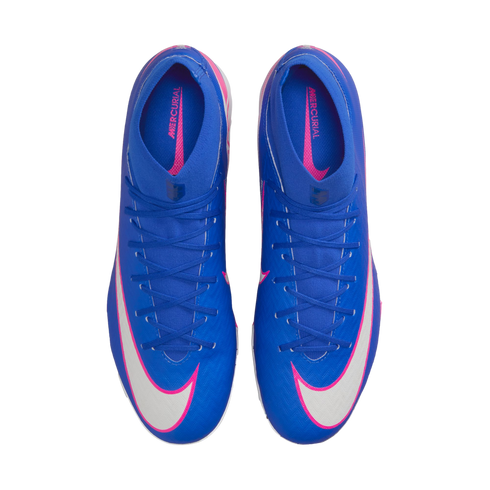 Top-down view of blue Nike Mercurial soccer cleats with white swooshes and pink accents on a black background.