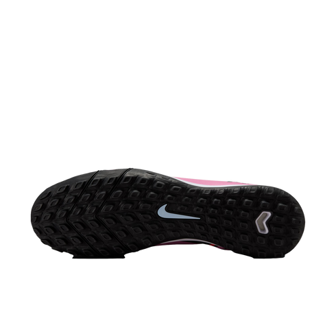 The black, multi-studded sole of a pink Nike soccer shoe features a light blue swoosh in the center and a white chevron logo on the heel.