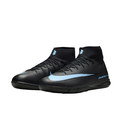 A pair of black Nike indoor soccer shoes with light blue accents and a high-top ankle collar against a black background.
