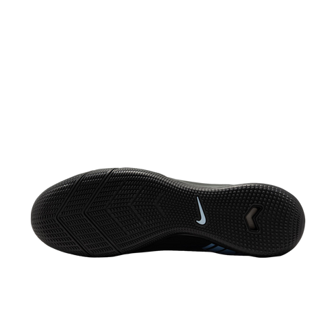 Bottom sole of a black Nike shoe with various textured grip patterns and a light blue swoosh logo in the center, displayed against a solid black background.