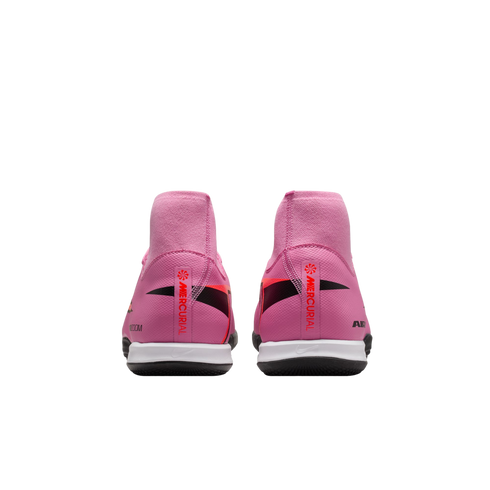 Rear view of pink Nike Mercurial soccer shoes with high-top collars and white soles on a black background.