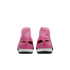 Rear view of pink Nike Mercurial soccer shoes with high-top collars and white soles on a black background.