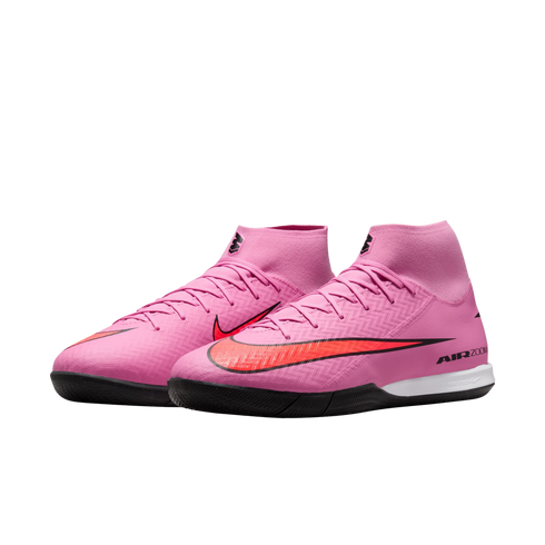 Pair of pink Nike Air Zoom soccer shoes with high-top collars and black soles, set against a black background.