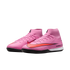 Pair of pink Nike Air Zoom soccer shoes with high-top collars and black soles, set against a black background.