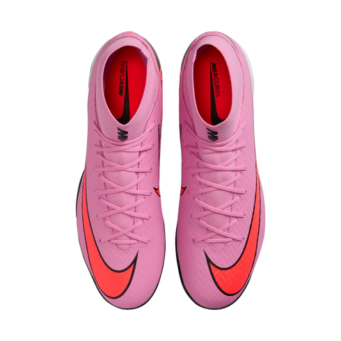 Top-down view of a pair of bright pink Nike Mercurial soccer cleats with vibrant orange swooshes on a black background.