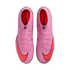 Top-down view of a pair of bright pink Nike Mercurial soccer cleats with vibrant orange swooshes on a black background.