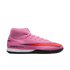 Vibrant pink Nike soccer shoe featuring a high-top collar, a large black and red swoosh, and "AIR ZOOM" branding on the side against a black background.