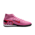 A pink Nike indoor soccer shoe with a high-top sock collar, red Nike swoosh, and large "M" on the heel, shown in profile against a black background.