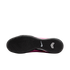 The textured black outsole of a pink Nike indoor soccer shoe, showing the tread pattern, a white Nike swoosh, and a white chevron-shaped logo.
