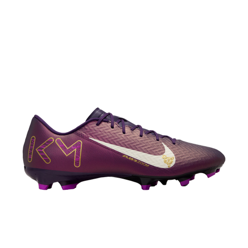 Profile view of a purple Nike soccer cleat featuring a white swoosh logo and gold "KM" initials on the heel, isolated on a white background.