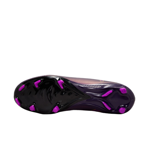 Bottom view of a purple soccer cleat featuring a black soleplate with bright magenta studs.
