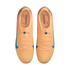 Top-down view of a pair of peach-colored Nike soccer cleats with blue accents and Kylian Mbappé's signature on the insoles.