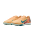A pair of peach Nike Air Zoom Mercurial turf soccer shoes with teal swooshes and colorful heel graphics, isolated on a black background.