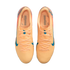 Top-down view of peach-colored Nike soccer cleats with blue accents and "KM" branding, isolated on a black background.