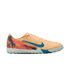 Side view of a peach-colored Nike Air Zoom soccer shoe with a blue swoosh, "KM" logo on the heel, and a mint green turf sole.