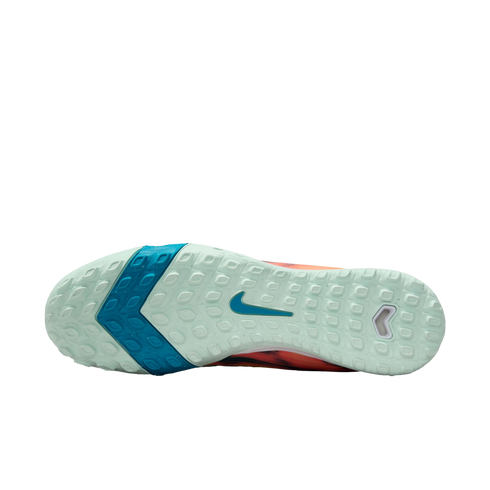 Bottom view of a Nike athletic shoe's mint green textured sole, featuring a blue chevron pattern and a teal swoosh logo.
